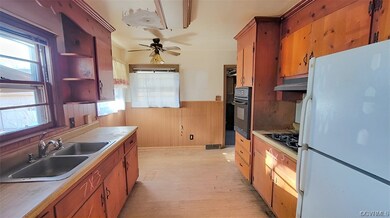 Kitchen featuring black appliances, ceiling fan, a