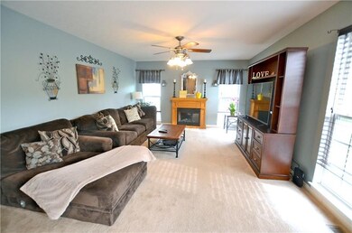 Cozy family room with fireplace & ceiling fan and 