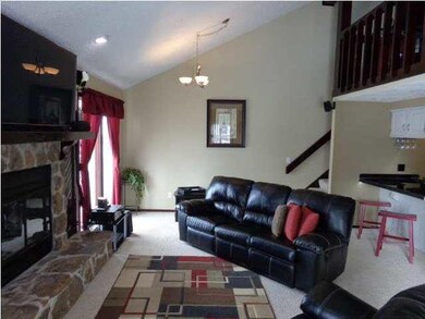 LIVING ROOM WITH LOFT ABOVE KITCHEN TO RIGHT.