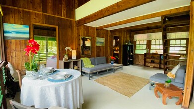 Main home living area, stairway to the loft above, Main bedroom and private lanai, bathroom, and kitchen to the right, next to the front entry stairs.