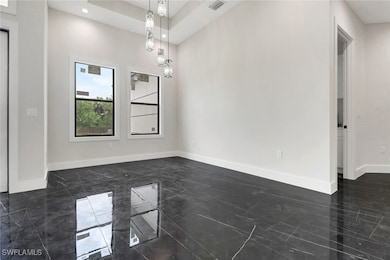 Dining room with tile flooring and modern lighting
