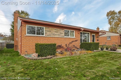 View of front facade with a chimney and brick siding