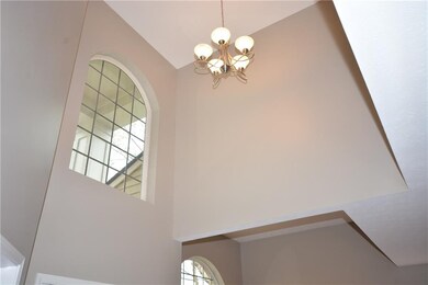 This picture highlights the arched window and new lighting in the two story entry.  Plant shelf is on right