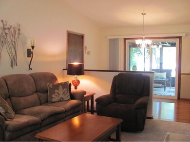 The vaulted living room is open to the dining room