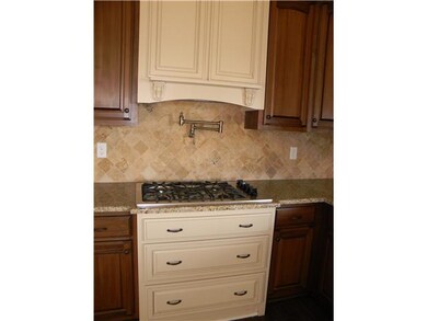 Tile backsplash with built-in pot filler