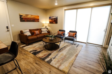 Living room with wood finished floors and recessed lighting