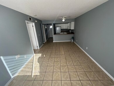 Unfurnished living room featuring light tile patte