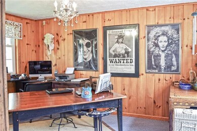The den, which is located off of the dining room, 