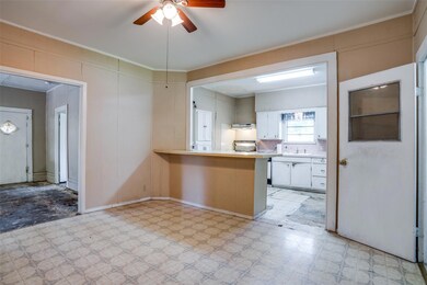 Kitchen featuring wall chimney exhaust hood, white