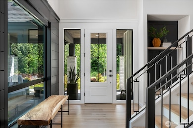 Welcoming entry with stairway of steel railings and wood steps.i