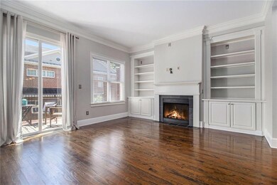 Features fireplace and custom bookcases.