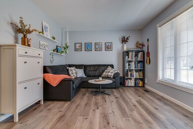 The living room has a large window overlooking the front yard that provides lots of natural light. 