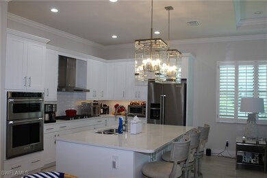 Kitchen featuring backsplash, appliances with stai