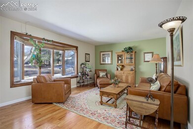 Living room with light hardwood / wood-style floor