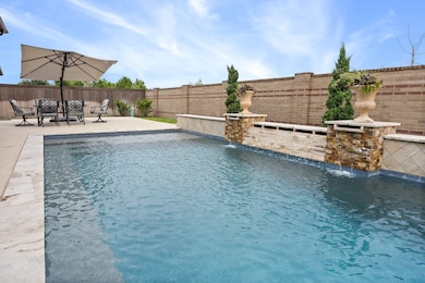 Enjoy your backyard oasis with a covered patio and