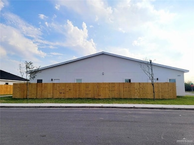 View of property exterior featuring fence
