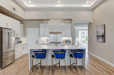 Kitchen with high quality fridge, a raised ceiling