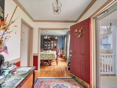 Entry foyer with hardwood floors and crown molding