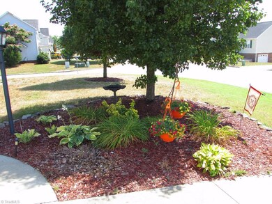 Garden bed brightens up the walkway to your front door.