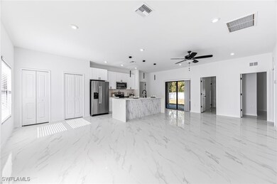 Kitchen featuring white cabinetry, visible vents,