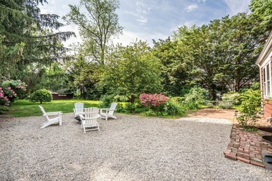 This pea stone garden area is ideal for relaxing by the firepit or enjoying a cool glass of anything while viewing the spacious yard.