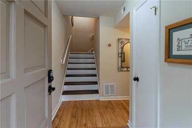 Entry foyer with coat closet, hardwood floors