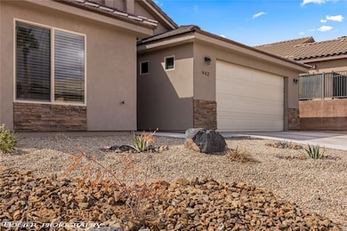 View of side of property featuring stone siding, s