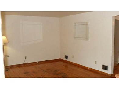 Living Room. The home features hard wood floors  i