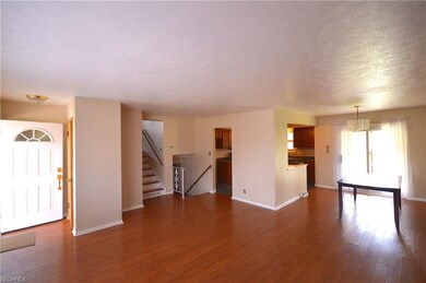 Living room with a view of the dining room and sec
