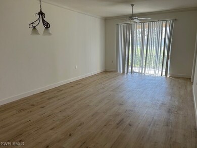 Empty room featuring crown molding, ceiling fan wi