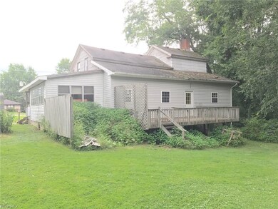 Rear view looking south showing the rear wood deck
