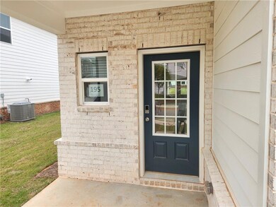 View of exterior entry with brick siding