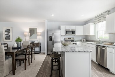 Open to an eat-in dining area - this floorplan is perfect for entertaining.  *Model Photo for reference*