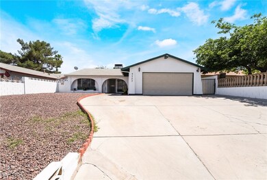 Ranch-style house with fence, stucco siding, drive