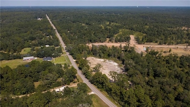 Aerial view of property's location with a heavily wooded area