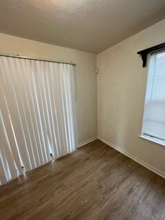 Spare room featuring dark hardwood / wood-style fl