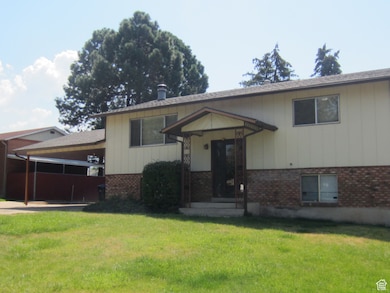 View of front of home featuring a front lawn, brick siding, and a shingled roof