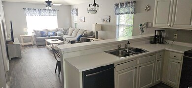 Kitchen featuring a peninsula, a sink, dishwasher,
