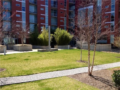 Patio off of the living area opens to common green space