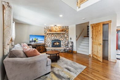 The beautiful river rock wood-burning fireplace is