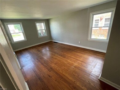 Wood floored empty room with vaulted ceiling