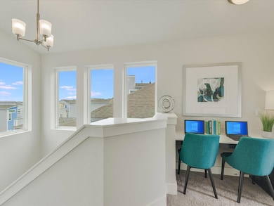 Home office featuring a chandelier and carpet