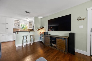 Living room featuring baseboards and dark wood-st