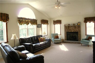 Living Room with gas log brick fireplace and high 