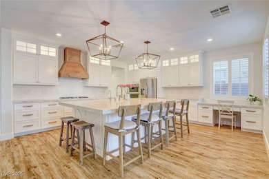 Kitchen with custom exhaust hood, stainless steel