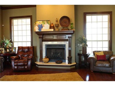 Living Room. Custom Mantel with lots of crown molding and marble around fireplace