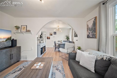Living room featuring arched walkways, visible ven