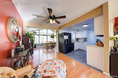 Living area featuring light wood-type flooring and a ceiling fan