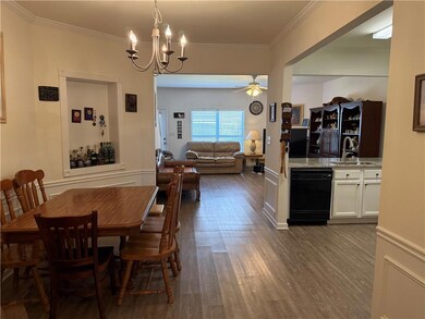 Dining space with wood finished floors, ceiling fa