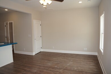 Second half of the Great Room.  Door on the right is a deep Pantry.  Door on the left is the Half Bathroom.